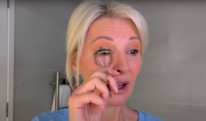 want an everyday glow try this natural makeup tutorial for over 50s, Curling lashes with an eyelash curler