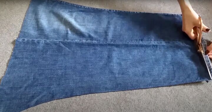 how to make a cute diy denim crop top out of a pair of old jeans, Cutting open the side seam of the jeans
