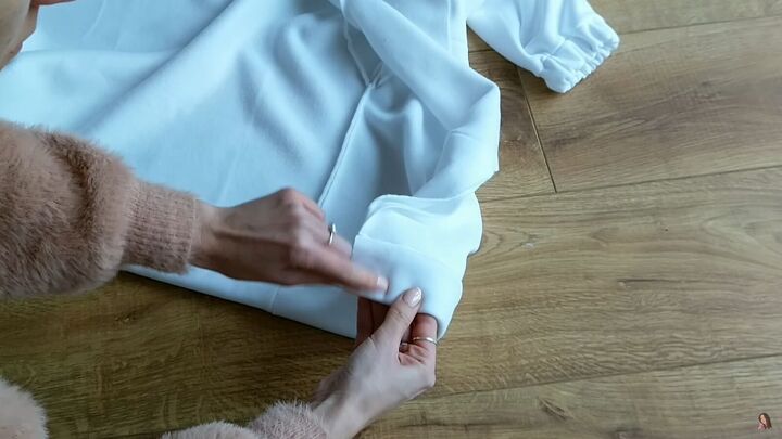 how to make your own zip up hoodie from scratch, Sewing elastic into the hem