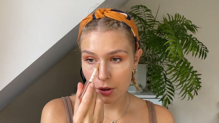 how to cover flaky skin with makeup for a light natural look, Applying concealer under the eyes