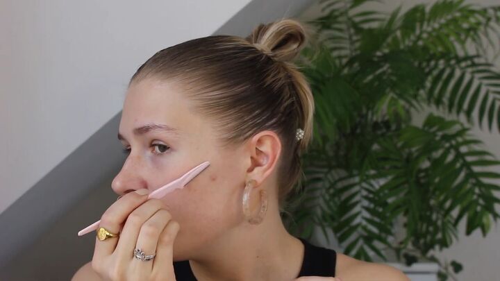 how to create a glowy bronze makeup look for spring summer, Using a dermaplaner on facial hair