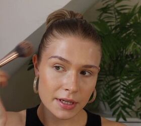 how to create a glowy bronze makeup look for spring summer, Applying bronzer to the temples