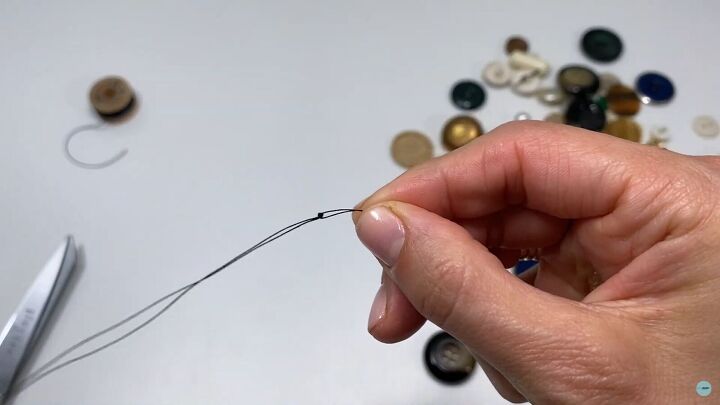got a stash of buttons at home try out this button bracelet tutorial, Double threading the button thread and tying a knot