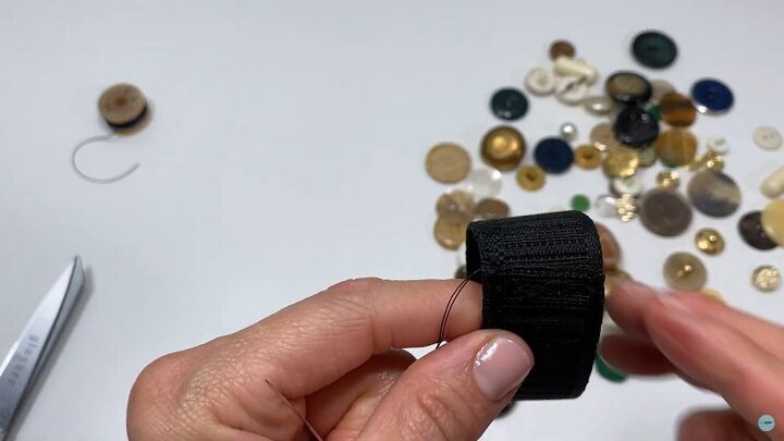 got a stash of buttons at home try out this button bracelet tutorial, Inserting the needle into the elastic