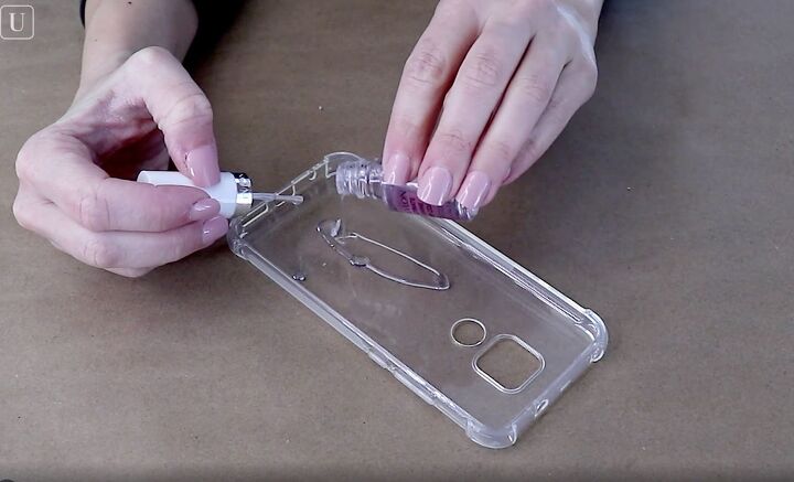 how to easily make a pretty pressed flower phone case for spring, Pouring clear nail polish into the phone case