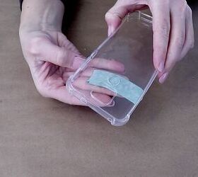 how to easily make a pretty pressed flower phone case for spring, Covering the holes in the phone case with tape