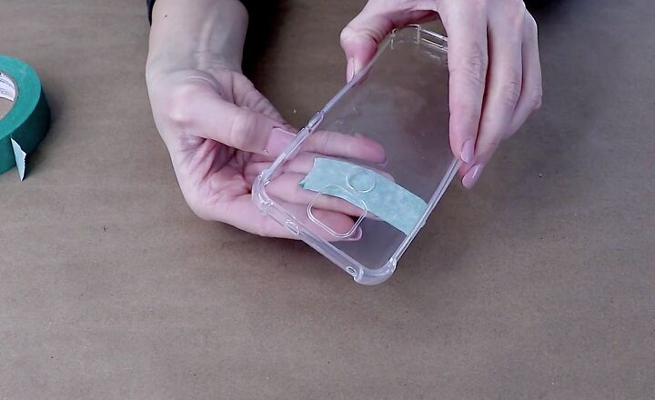 how to easily make a pretty pressed flower phone case for spring, Covering the holes in the phone case with tape