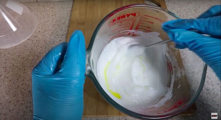 how to make hand lotion that will hydrate moisturize your hands, Mixing the essential oils with a spoon