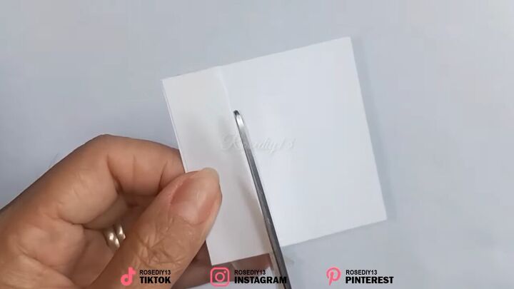 how to make fake nails out of nail polish paper in 7 simple steps, Cutting a piece of paper with scissors