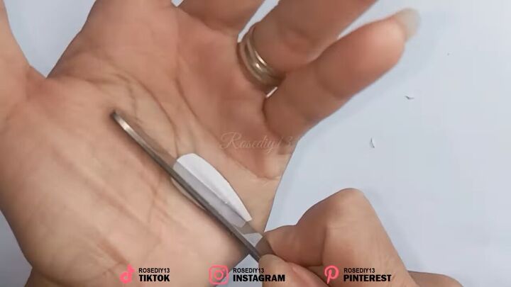 how to make fake nails out of nail polish paper in 7 simple steps, Creating a curve in the paper using scissors