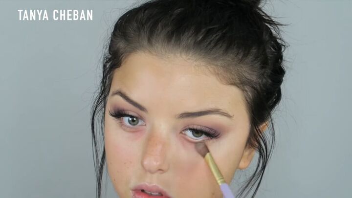 how to do a purple smokey eye for a glam spring summer look, Color correcting under the eyes with a peach tone