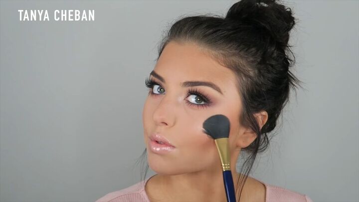 how to do a purple smokey eye for a glam spring summer look, Placing highlight on top of the cheekbones