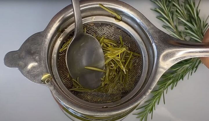 how to make use an effective diy rosemary oil for hair, Pressing the rosemary with the back of a spoon