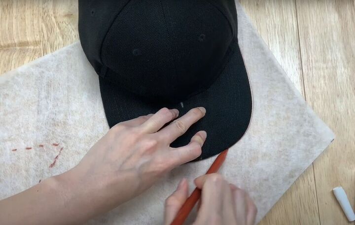 how to make a baseball cap out of an old pair of denim jeans, Marking the center of the cap brim