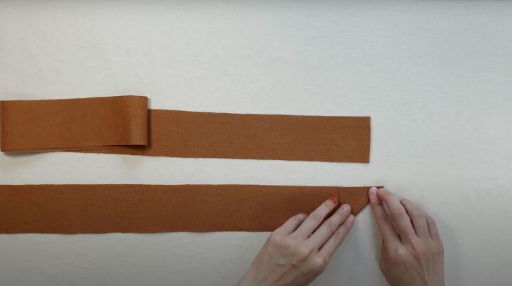 how to easily make a diy crossbody strap for a bag or purse, Folding the corner of the strap