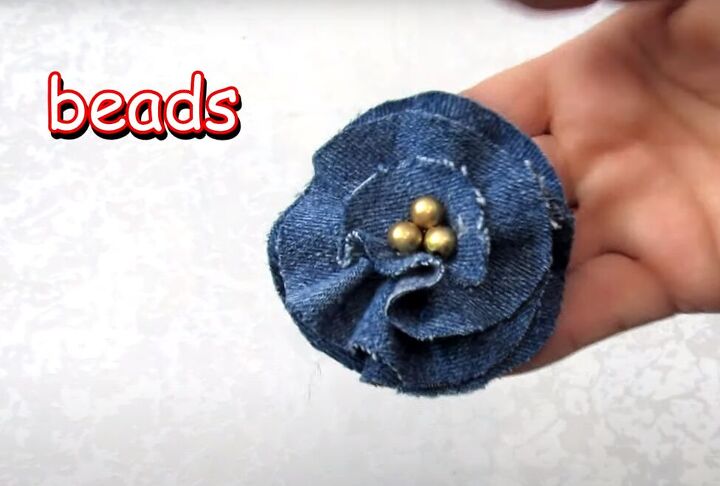 how to make a diy denim bracelet with a cute flower design, Adding decorative beads to the flower center