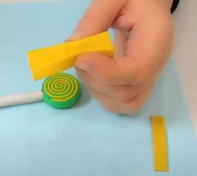 how to make adorable diy candy hair clips using foam glue, Folding a yellow piece of foam