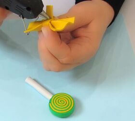 how to make adorable diy candy hair clips using foam glue, Applying hot glue to the bow