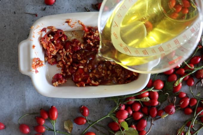 how to make rosehip oil to heal your skin, Pouring almond oil into the casserole