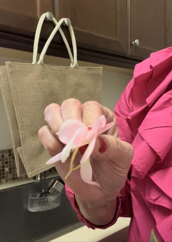 a diy floral tote bag for spring, See how close I am cutting the petals to the actual fabric thereby minimizing any of the plastic stems on the flowers