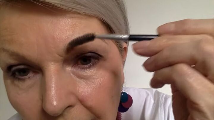 how best to measure groom shape eyebrows for older women, Using a spoolie to brush the product through