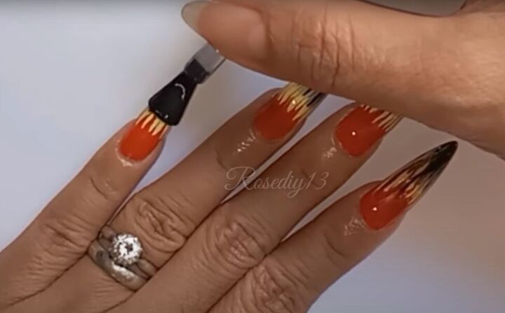 how to do easy diy gel nail art in fiery orange yellow black, Applying a clear top coat to nails