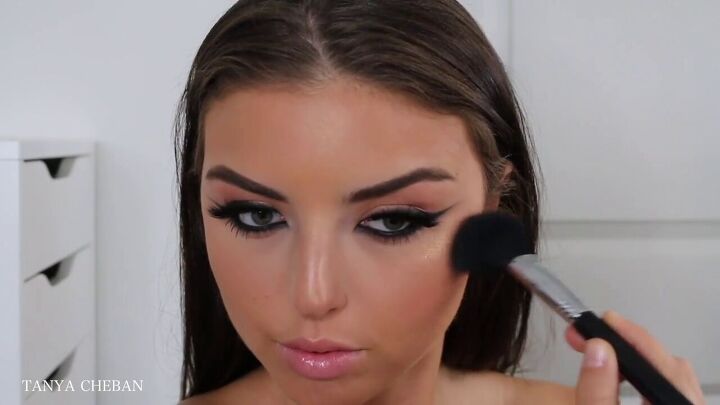 how to recreate kim kardashian s makeup complete with contour, Applying blush to the cheeks with a brush