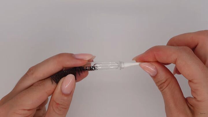 how to clean false lashes easily safely so you can reuse them, Applying lash glue remover to a cotton bud