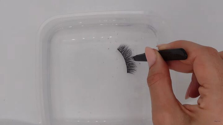 how to clean false lashes easily safely so you can reuse them, Taking the lashes out of water with tweezers