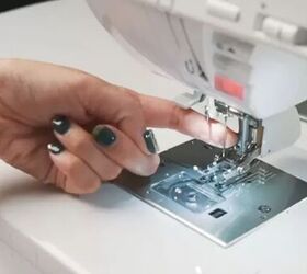 how to replace a sewing machine needle in under 5 minutes, finger touching sewing machine needle