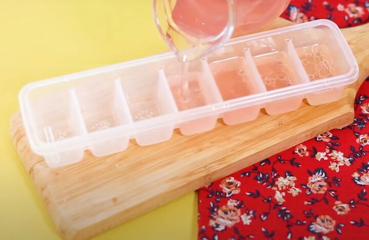 how to make soothing diy ice cubes for your face 4 easy recipes, Pouring the rosewater mixture into an ice cube tray