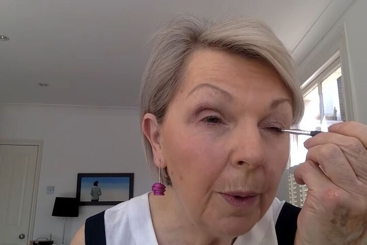 how to do light summer eye makeup over 60 in 8 simple steps, Lining the lash lines with blue