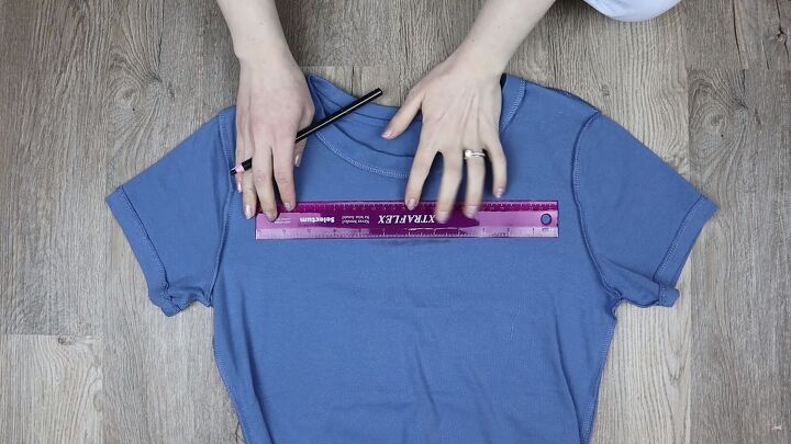 6 unique diy cut out t shirt designs that are quick easy to do, Using a ruler to mark the cutout