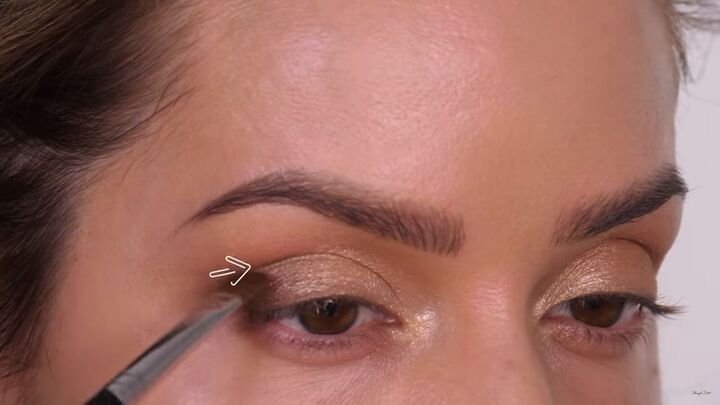 how to do a classic brown gold eyeshadow look that suits everyone, Applying a minky sandstone shade to the outer third of the lid