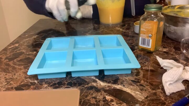 how to make a melt pour turmeric honey soap recipe, Spraying the mod with alcohol