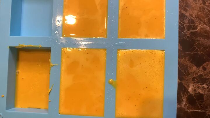 how to make a melt pour turmeric honey soap recipe, Spraying the top of the soap with alcohol spray