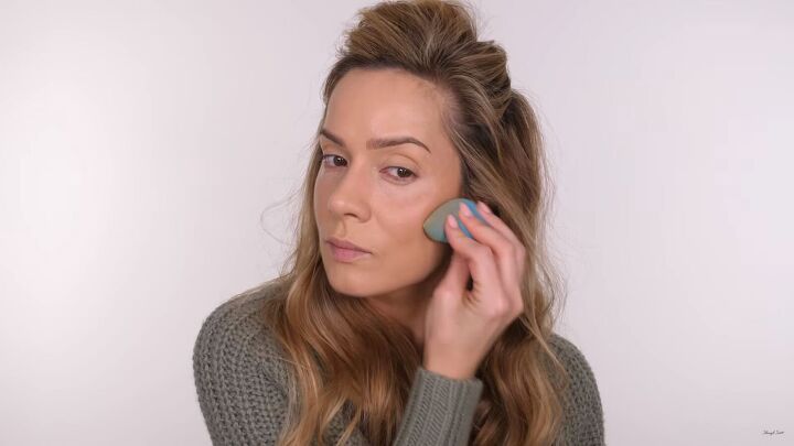 fuss free makeup for beginners how to do an easy glam look, Blending the cream contour with a makeup sponge