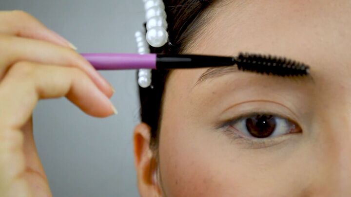 everyday eyebrow tutorial how to get full defined brows, Brushing eyebrows with a spoolie brush