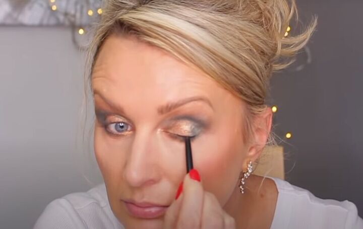 how to do glam dramatic green gold eye makeup, Adding kohl eyeliner to the upper lash line