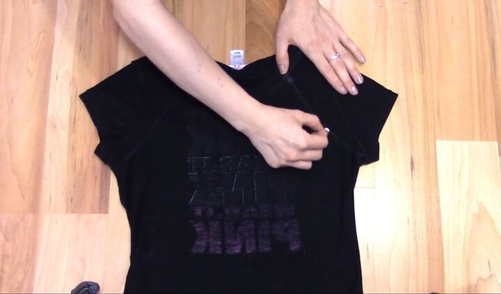 how to cut t shirts into tank tops halter tops in a few easy steps, Drawing a curved line below the sleeve