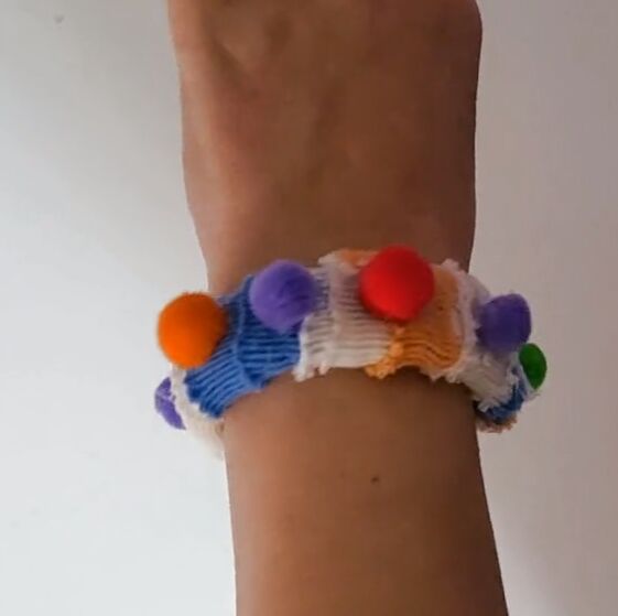 how to repurpose a shrunken sweater into 4 fun accessories, DIY sweater bracelet with pom poms