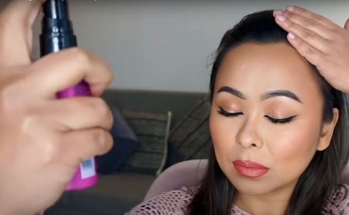date night makeup how to create a soft glamorous look for a date, Spraying the date night makeup with setting spray