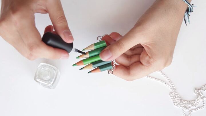 3 cute pieces of diy jewelry made from colored pencils, Painting the ends with clear nail polish