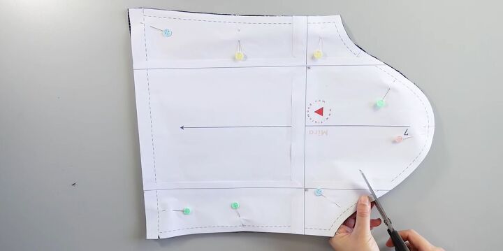 how to sew a cute diy babydoll dress using a pattern, Marking the fabric at the key points on the pattern