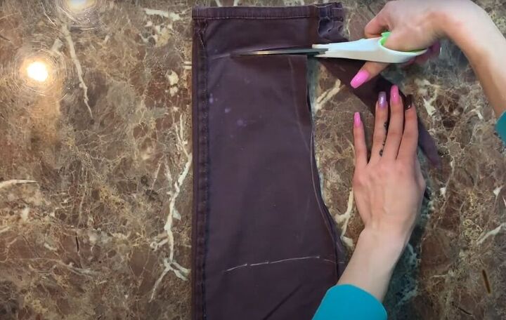 how to easily make a cute diy overall dress out of old pants, Cutting out the DIY overall dress pattern