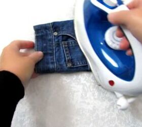 how to make a cute diy cell phone bag out of jean pockets, Pressing the bag with an iron