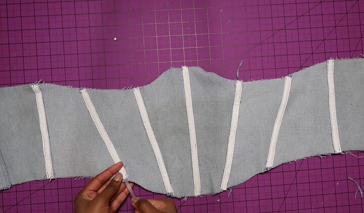 how to make an on trend diy corset belt out of old jeans, Inserting the boning into the DIY corset belt