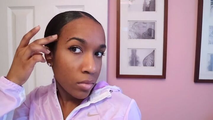 how to easily do a chic sleek low bun on natural hair, Fixing the flyaways