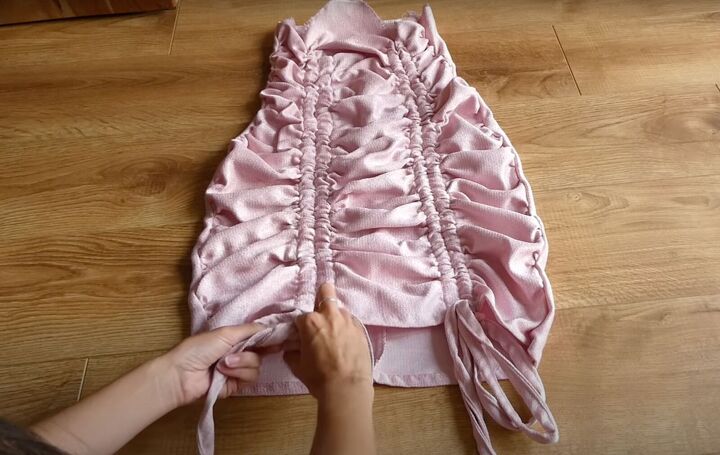 how to sew a dreamy diy ruffle dress out of old curtains, Pulling the drawstrings to ruffle the skirt
