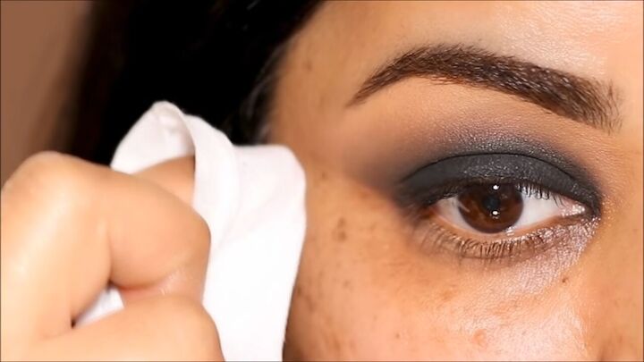 how to do a glam black smokey eye with glitter without making a mess, Cleaning up the eyeshadow with a makeup wipe